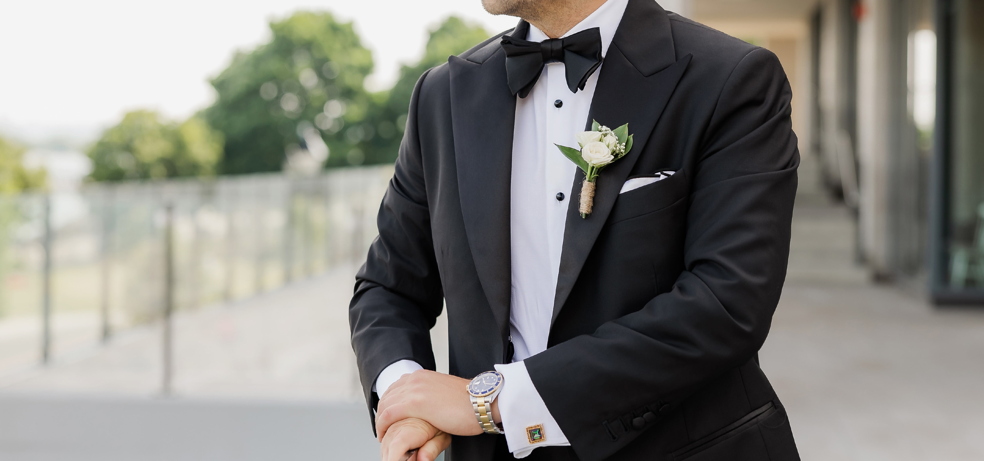 Groom wearing a bespoke King & Bay black tuxedo at wedding